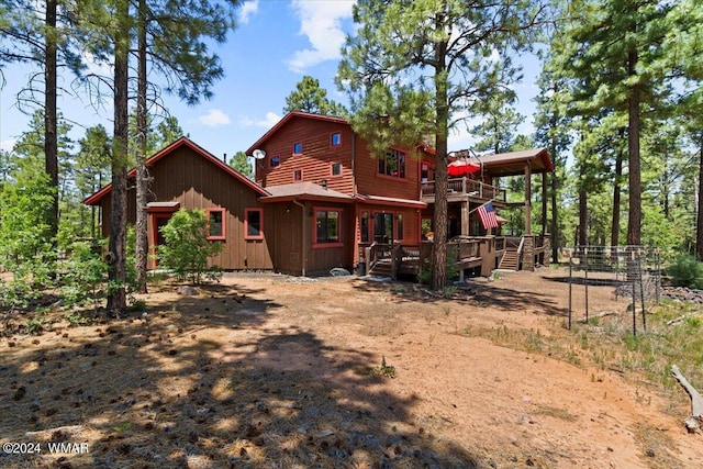 rear view of property with a wooden deck