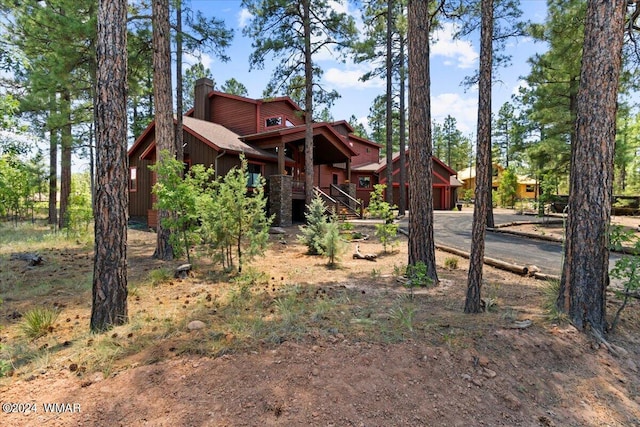 exterior space with driveway and a chimney