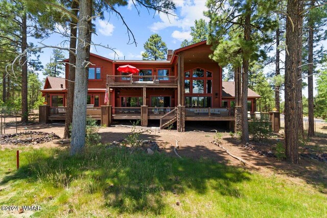 back of property with a wooden deck