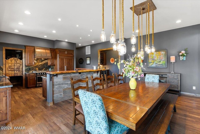 dining area featuring baseboards, dark wood finished floors, and recessed lighting