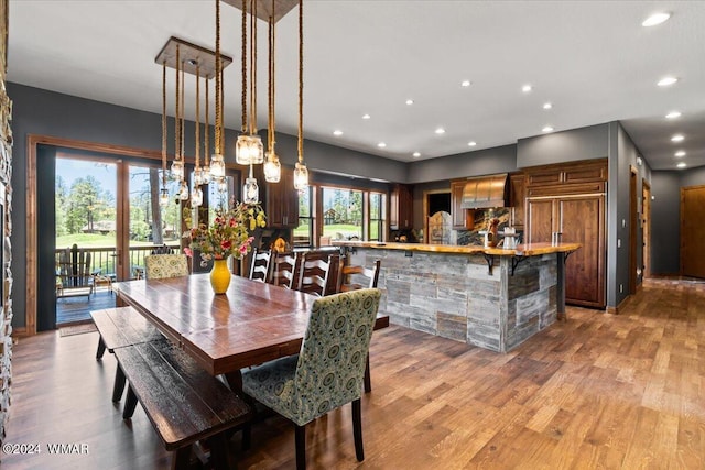 dining room with light wood-style flooring and recessed lighting