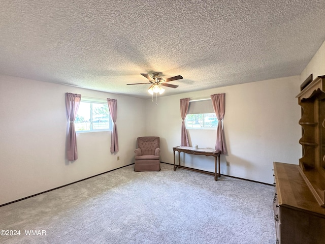 unfurnished room with carpet, a ceiling fan, and baseboards