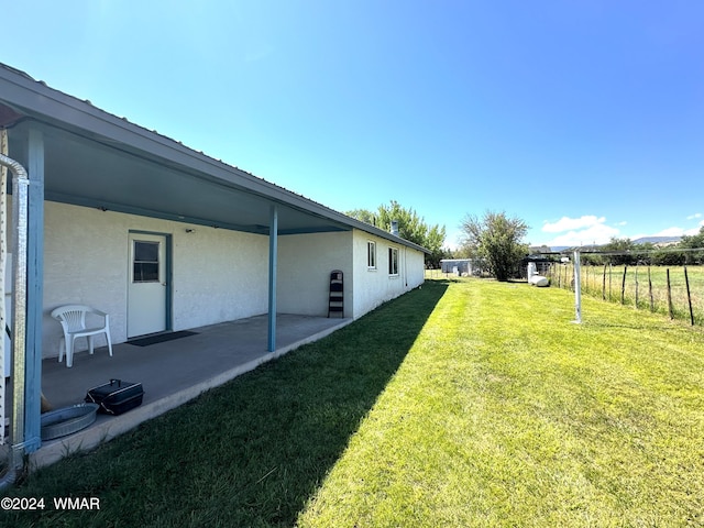 view of yard with a patio and fence