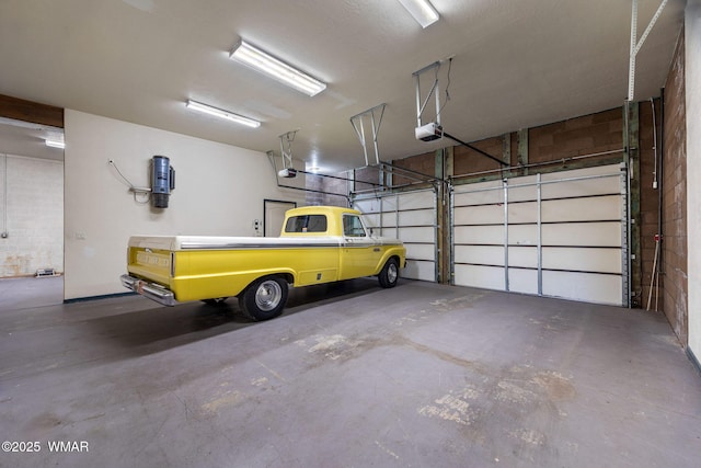 1561 S Canyon Ridge Trl, Show Low, AZ 85901 - garage featuring a garage door opener and a central vacuum unit
