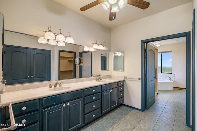 1561 S Canyon Ridge Trl, Show Low, AZ 85901 - bathroom with double vanity, a ceiling fan, tile patterned flooring, a garden tub, and baseboards