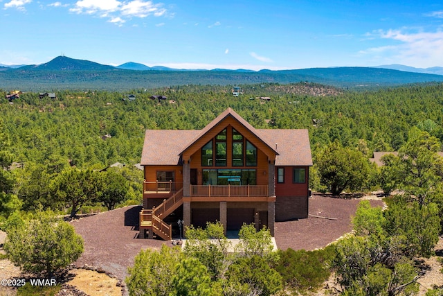 1561 S Canyon Ridge Trl, Show Low, AZ 85901 - view of front of house featuring a wooded view, a mountain view, stairs, and an attached garage