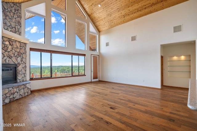 1561 S Canyon Ridge Trl, Show Low, AZ 85901 - unfurnished living room featuring high vaulted ceiling, hardwood / wood-style flooring, a fireplace, baseboards, and wooden ceiling