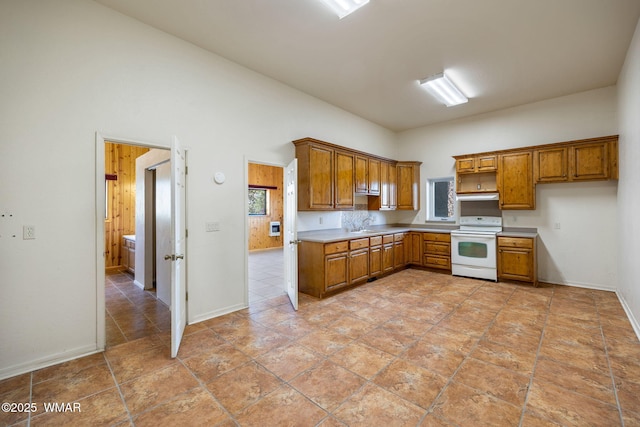 1561 S Canyon Ridge Trl, Show Low, AZ 85901 - kitchen featuring white electric range, brown cabinetry, light countertops, and under cabinet range hood
