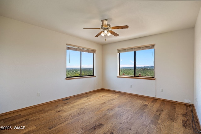 1561 S Canyon Ridge Trl, Show Low, AZ 85901 - spare room featuring a ceiling fan, wood finished floors, and baseboards