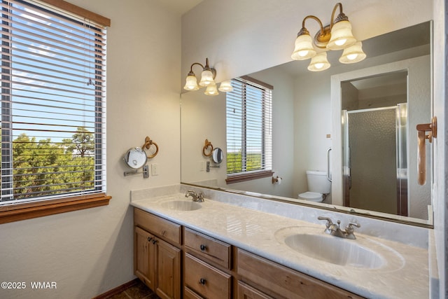 1561 S Canyon Ridge Trl, Show Low, AZ 85901 - bathroom featuring a chandelier, toilet, double vanity, and a stall shower