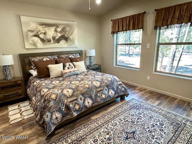3180 N Eagles Creek Dr, Show Low, AZ 85901 - bedroom featuring wood finished floors and vaulted ceiling