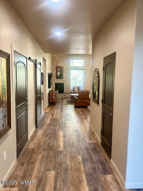 3180 N Eagles Creek Dr, Show Low, AZ 85901 - corridor featuring dark wood-type flooring and a barn door
