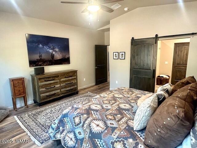 3180 N Eagles Creek Dr, Show Low, AZ 85901 - bedroom with a barn door, wood finished floors, vaulted ceiling, and ceiling fan