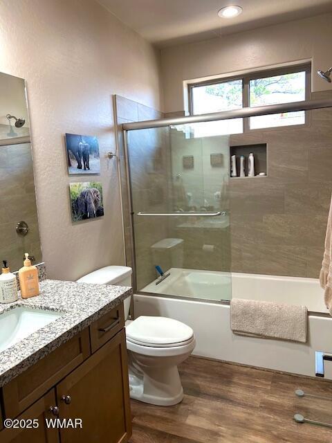 3180 N Eagles Creek Dr, Show Low, AZ 85901 - full bath featuring healthy amount of natural light, vanity, enclosed tub / shower combo, and wood finished floors