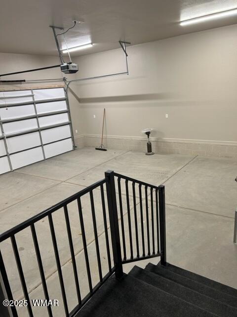 3180 N Eagles Creek Dr, Show Low, AZ 85901 - garage featuring baseboards and a garage door opener