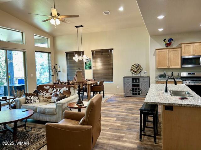 3180 N Eagles Creek Dr, Show Low, AZ 85901 - living room featuring wood finished floors, a ceiling fan, a chandelier, recessed lighting, and lofted ceiling