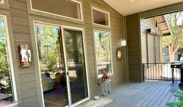 3180 N Eagles Creek Dr, Show Low, AZ 85901 - doorway featuring wood walls, lofted ceiling, hardwood / wood-style flooring, and healthy amount of natural light