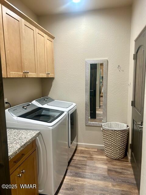 3180 N Eagles Creek Dr, Show Low, AZ 85901 - laundry room with cabinet space, dark wood-style flooring, and washing machine and clothes dryer