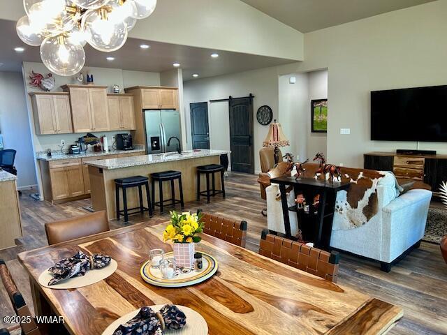 3180 N Eagles Creek Dr, Show Low, AZ 85901 - dining area featuring a barn door, lofted ceiling, dark wood-style flooring, a chandelier, and recessed lighting
