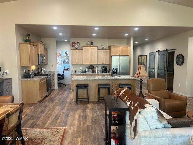 3180 N Eagles Creek Dr, Show Low, AZ 85901 - kitchen with range, stainless steel refrigerator with ice dispenser, light brown cabinetry, dark wood-style flooring, and lofted ceiling