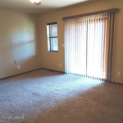 spare room with carpet floors and baseboards