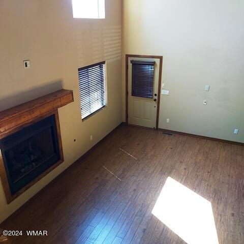 unfurnished living room featuring a fireplace and wood finished floors