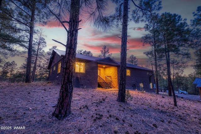 7125 Elk Trl, Show Low, AZ 85901 - property exterior at dusk with metal roof and a standing seam roof