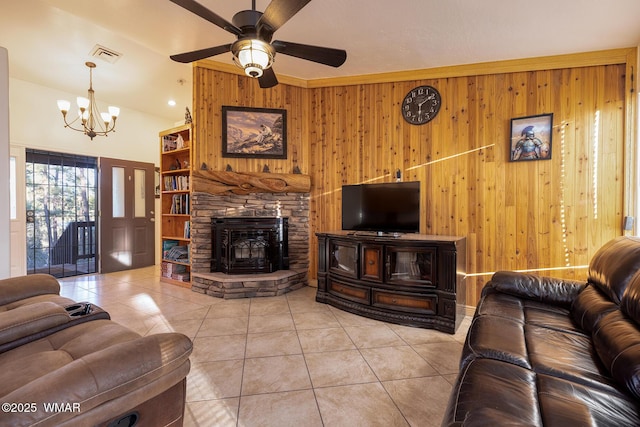 7125 Elk Trl, Show Low, AZ 85901 - living area with wood walls, light tile patterned floors, a chandelier, ceiling fan, and a fireplace