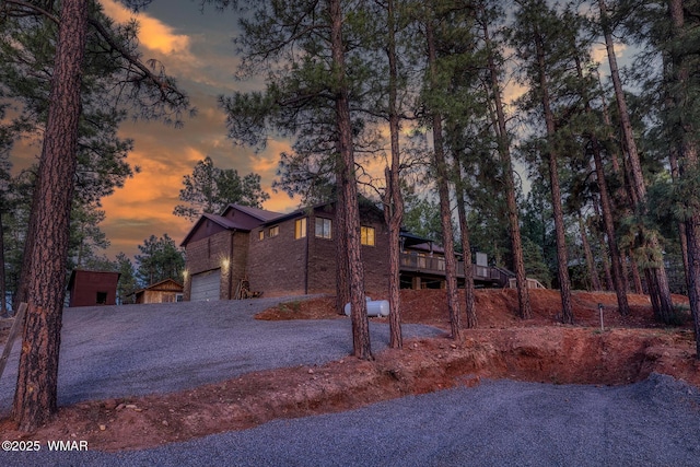 7125 Elk Trl, Show Low, AZ 85901 - chalet / cabin with driveway, a deck, an attached garage, and brick siding