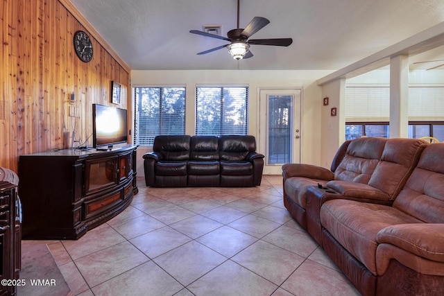 7125 Elk Trl, Show Low, AZ 85901 - living area featuring a ceiling fan, wood walls, light tile patterned flooring, and lofted ceiling