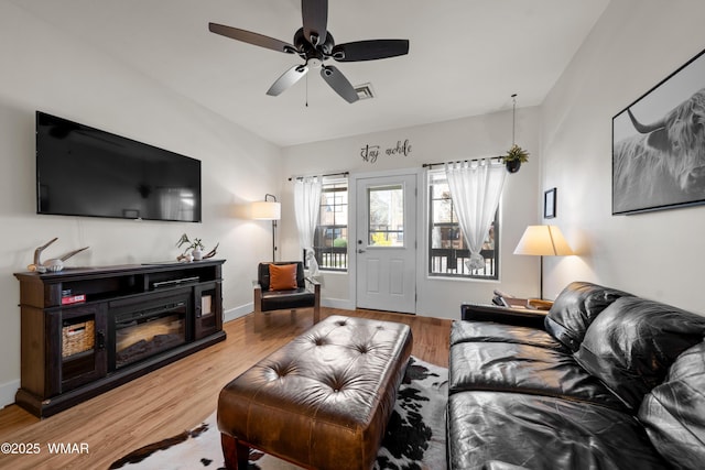2395 Quarter Horse Trl, Overgaard, AZ 85933 - living area featuring a ceiling fan, baseboards, visible vents, and wood finished floors