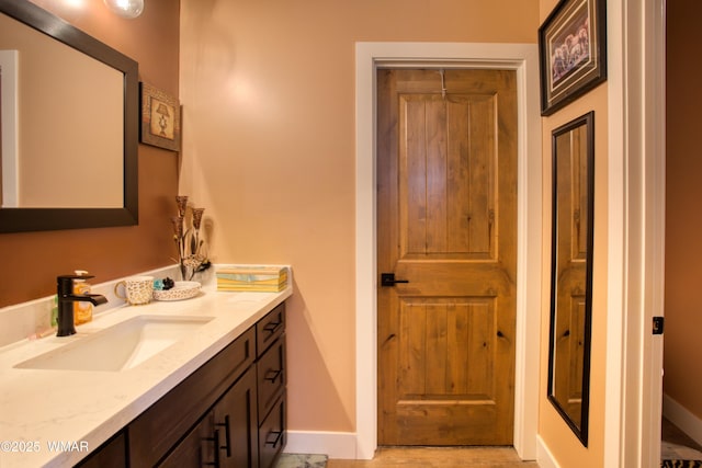 bathroom featuring baseboards and vanity