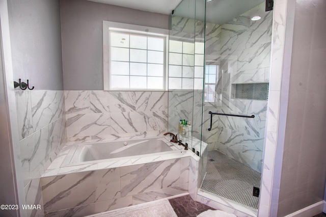 full bathroom featuring a marble finish shower, a garden tub, and marble finish flooring