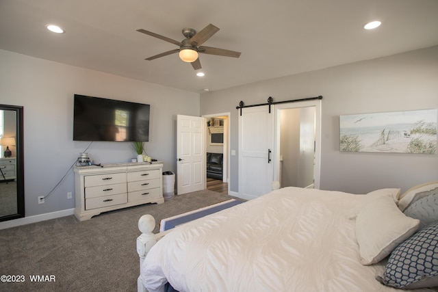 carpeted bedroom with a barn door, recessed lighting, baseboards, and a ceiling fan
