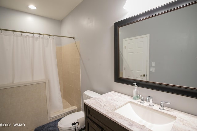 bathroom with toilet, a shower stall, and vanity