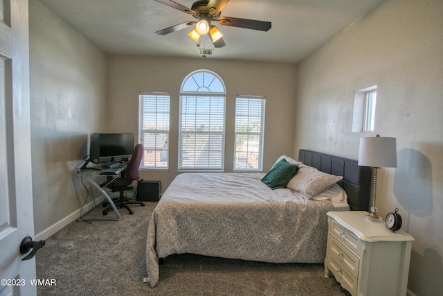 bedroom with dark colored carpet, baseboards, and a ceiling fan