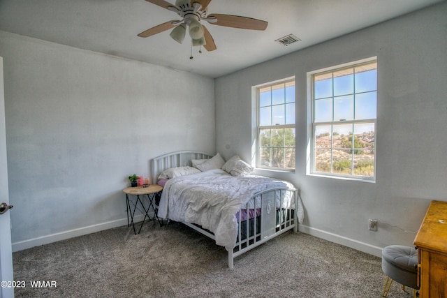 carpeted bedroom with baseboards and ceiling fan