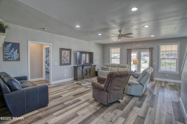 living room featuring recessed lighting, ceiling fan, baseboards, and wood finished floors