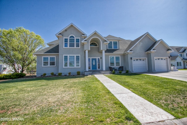 traditional-style home with concrete driveway, stucco siding, a front lawn, and a garage