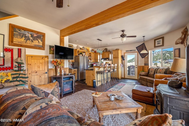 living room featuring ceiling fan and beamed ceiling