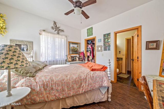 bedroom featuring dark wood finished floors, connected bathroom, ceiling fan, a walk in closet, and a closet