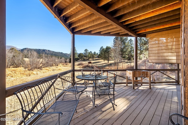 wooden deck featuring outdoor dining area