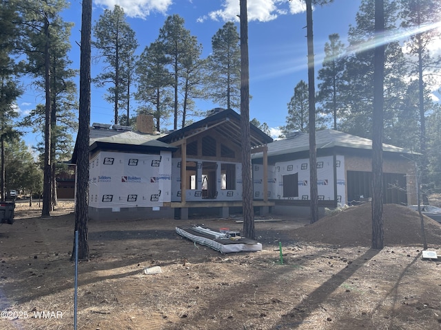 rear view of house featuring crawl space and a chimney