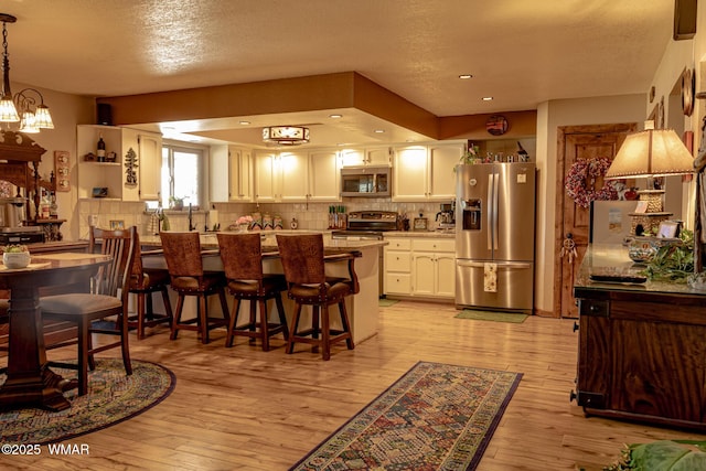 1092 Cedar Dr, Show Low, AZ 85901 - dining space with light wood-type flooring, a chandelier, a textured ceiling, and recessed lighting