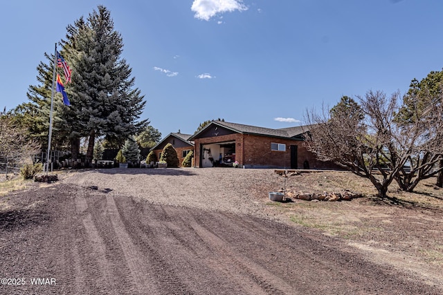 1092 Cedar Dr, Show Low, AZ 85901 - ranch-style home with dirt driveway and brick siding