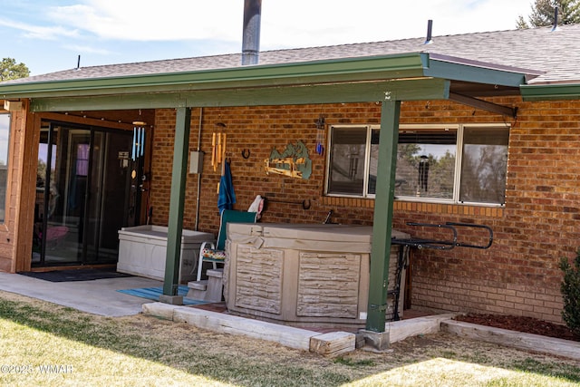 1092 Cedar Dr, Show Low, AZ 85901 - back of property with brick siding, a hot tub, and a shingled roof