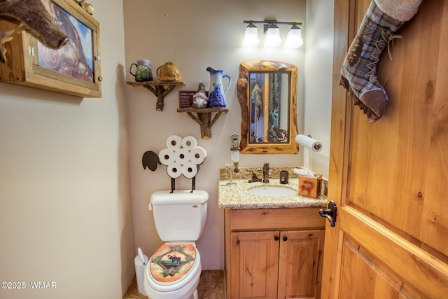 half bath featuring vanity and toilet