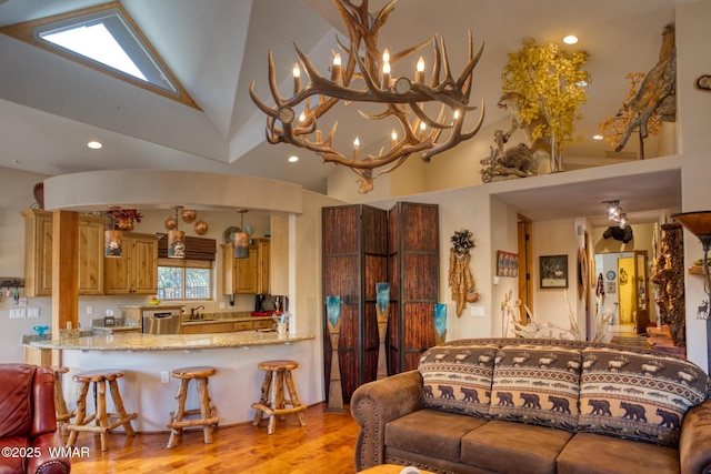 living area featuring light wood finished floors, high vaulted ceiling, and recessed lighting