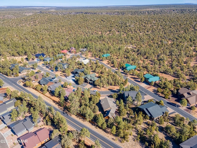 aerial view featuring a wooded view and a residential view