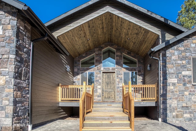 view of exterior entry featuring stone siding